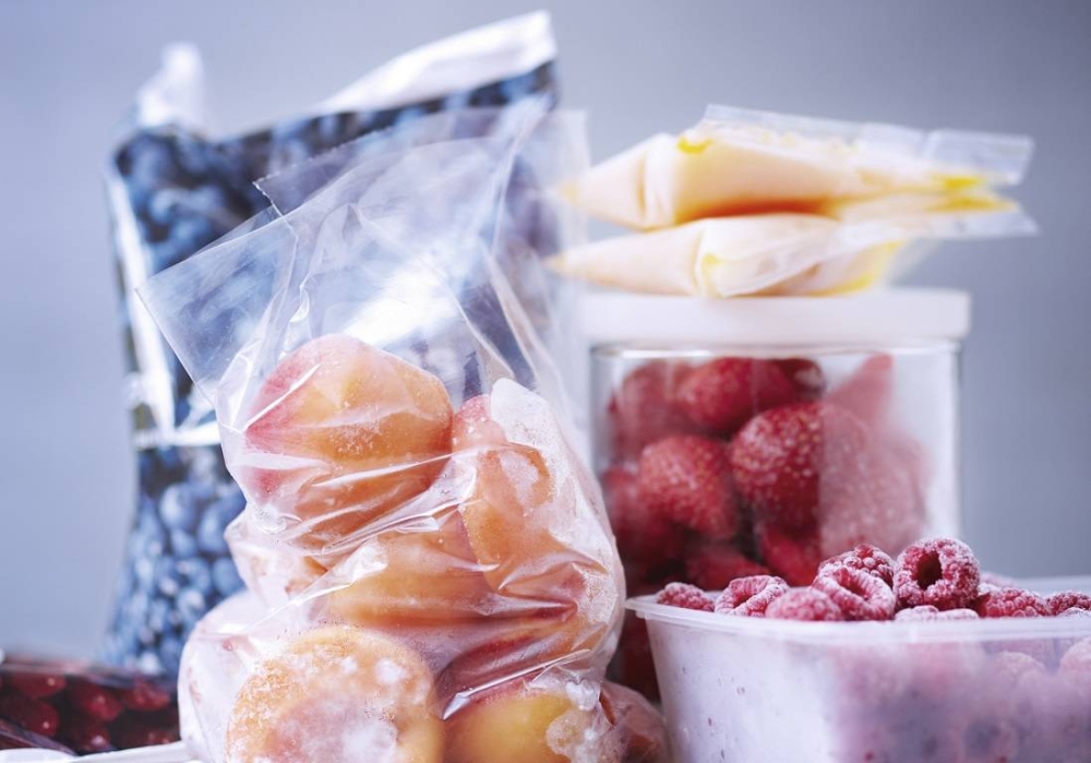 Influencer girl creating videos for social media at home, she is using a smartphone and a ring light