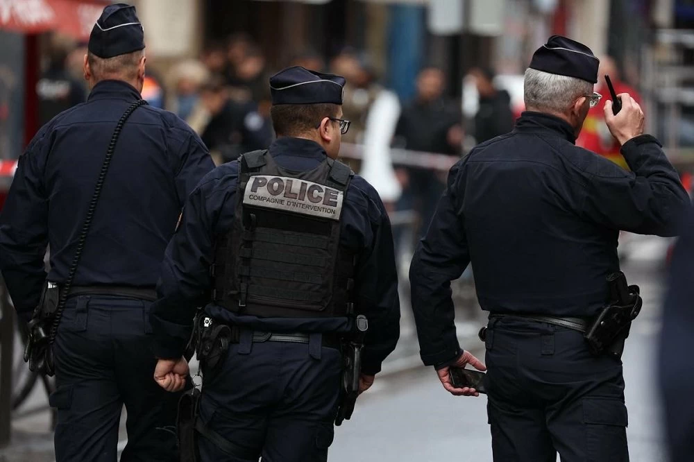 French police secure the street after several shots were fired along rue d'Enghien in the 10th arrondissement, in Paris on December 23, 2022. - Two people were killed and four injured in a shooting in central Paris on December 23, 2022, police and prosecutors said, adding that the shooter, in his 60s, had been arrested. The motives of the gunman remain unclear, with two of the four injured left in a serious condition, the French officials said. (Photo by Thomas SAMSON / AFP)