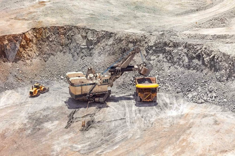 Electric rope shovel loading a dump truck at a copper mine in Peru